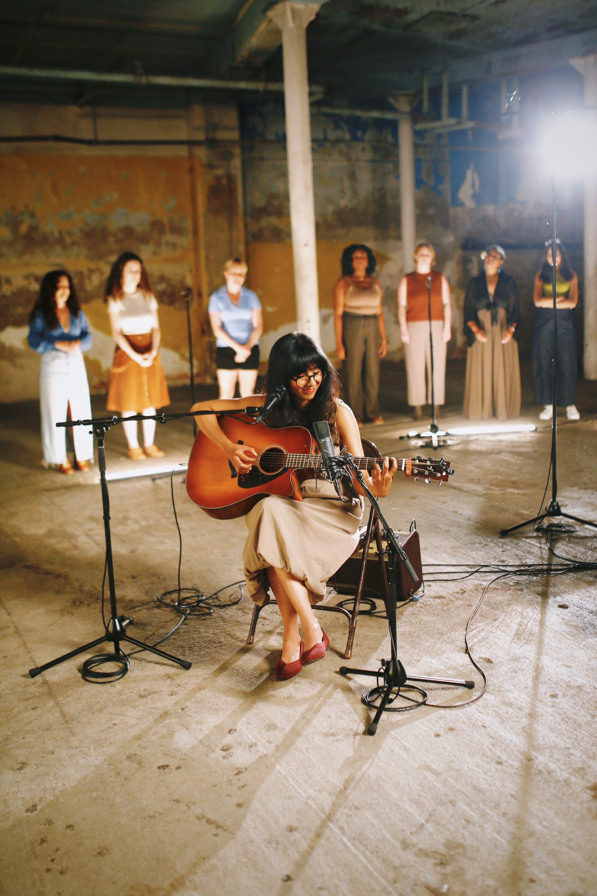 Shakthisree performing with the choir behind her